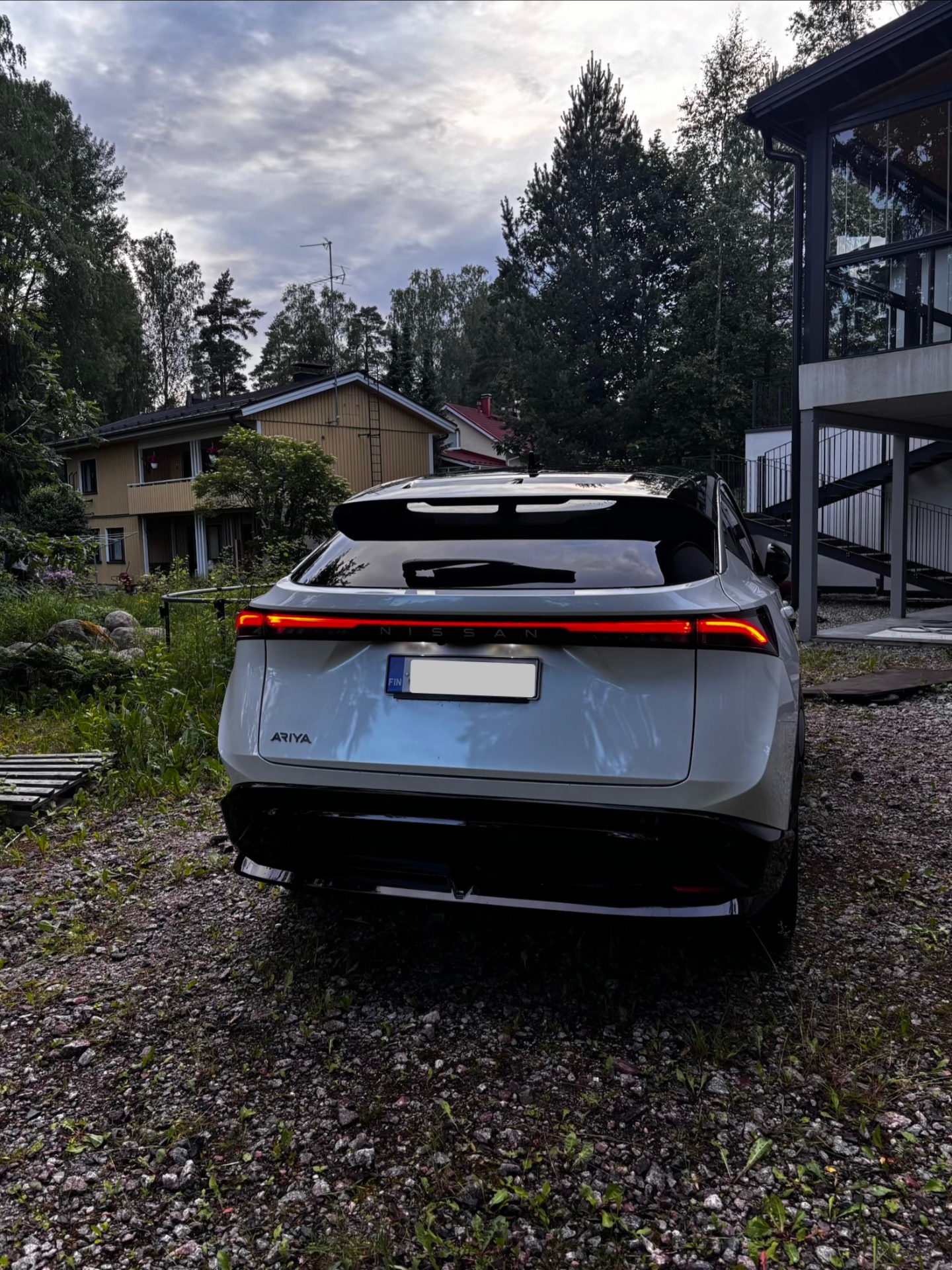 Valkoinen Nissan Ariya takaa ulkopesun jälkeen